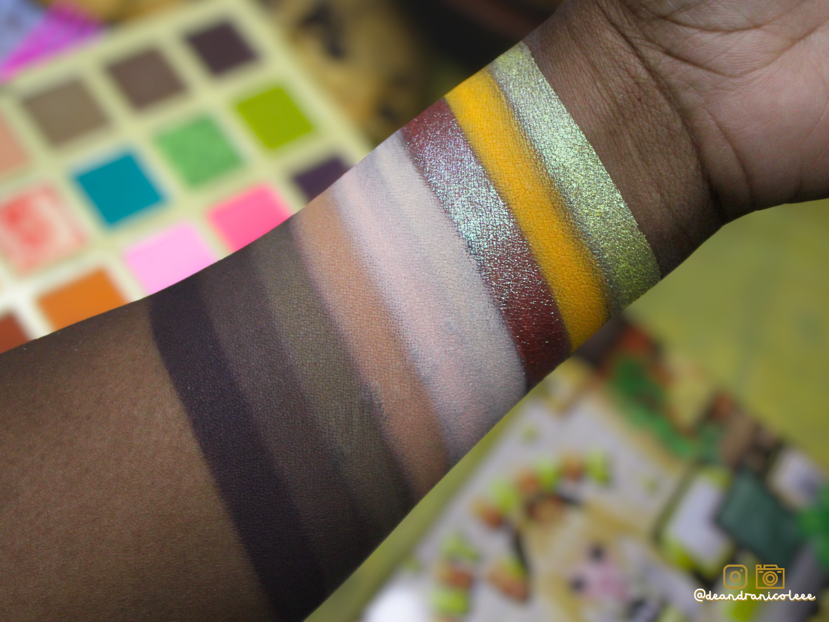 Color swatches on a hand with a blurred background